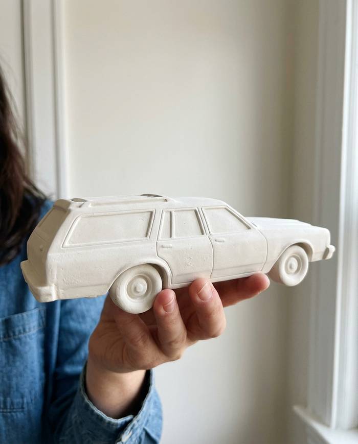 A custom car keepsake in matte engineered ceramic, shown on a shelf